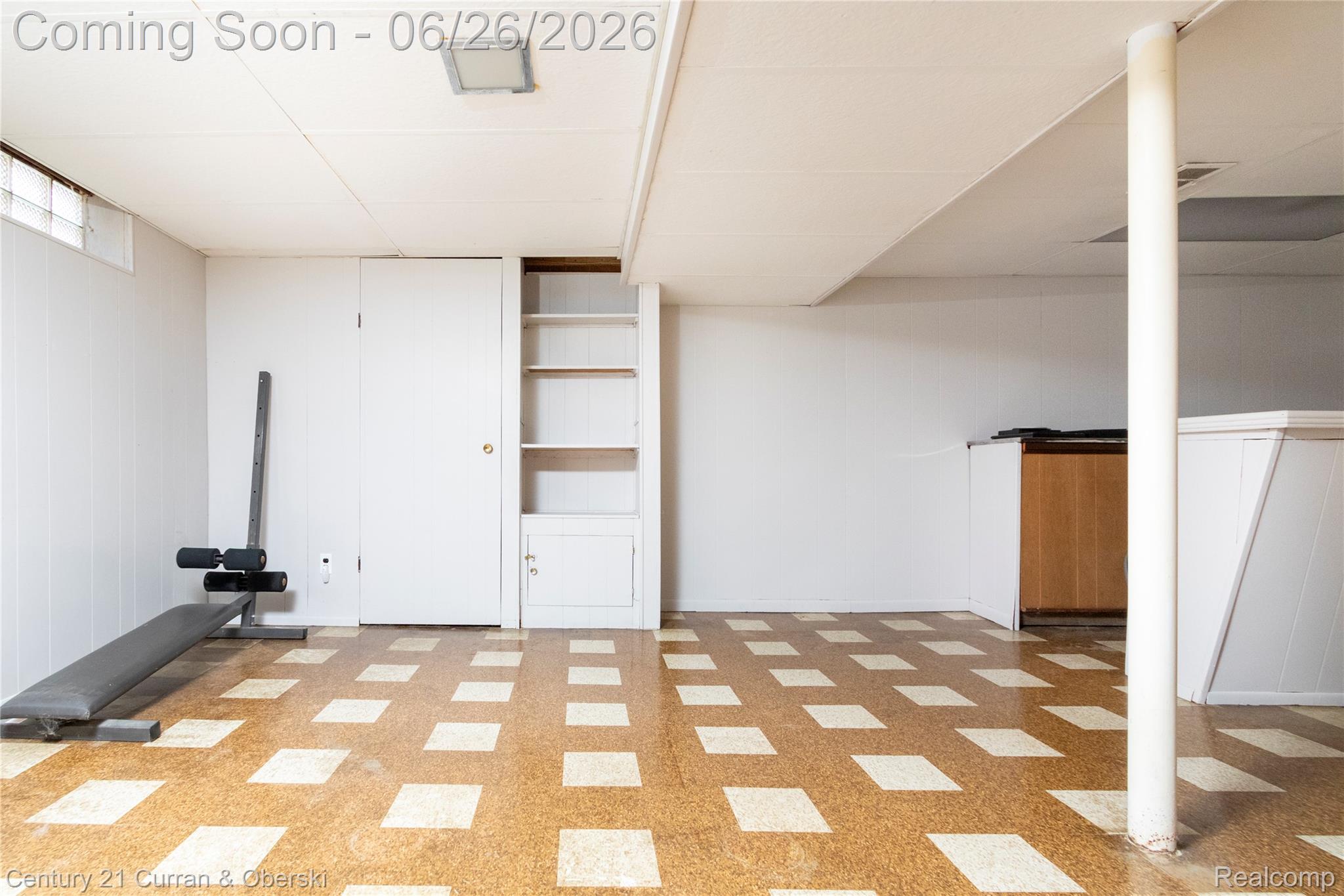 3220 Alice Street Dearborn, MI 48124 - Photo 27 of 39 Spacious lower level featuring patterned flooring, white paneling, and an acoustic tile ceiling with flush-mount lighting