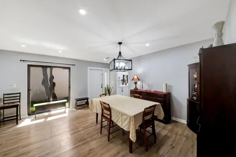 a view of a dining room with furniture window and wooden floor