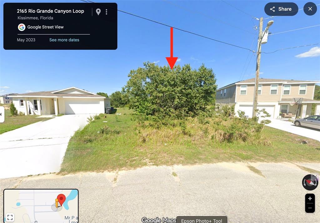 2159 Rio Grande Canyon Loop Poinciana, FL 34759 - Photo 4 of 25 a view of a street with a building in the background