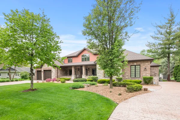 a front view of house with yard and green space