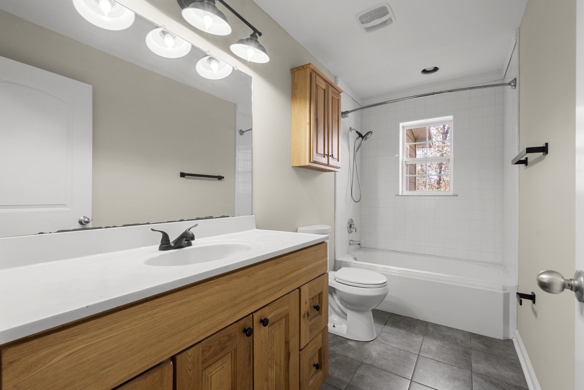 1148 Stoltz Road Centerville, TN 37033 - Photo 29 of 63 a bathroom with a sink a toilet a shower and a mirror