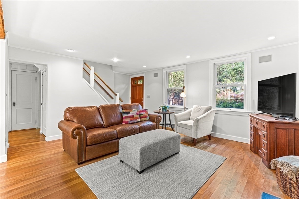 281 Cochituate Road Wayland, MA 01778 - Photo 14 of 38 a living room with furniture flat screen tv and hard wood flooring