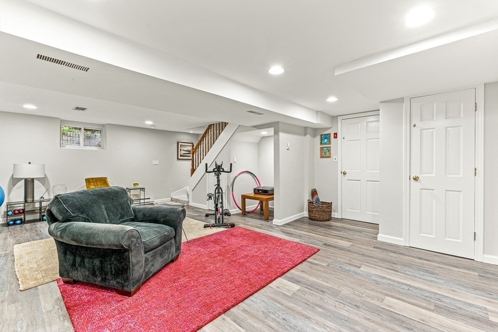 281 Cochituate Road Wayland, MA 01778 - Photo 27 of 38 a living room with furniture a rug and gym equipment
