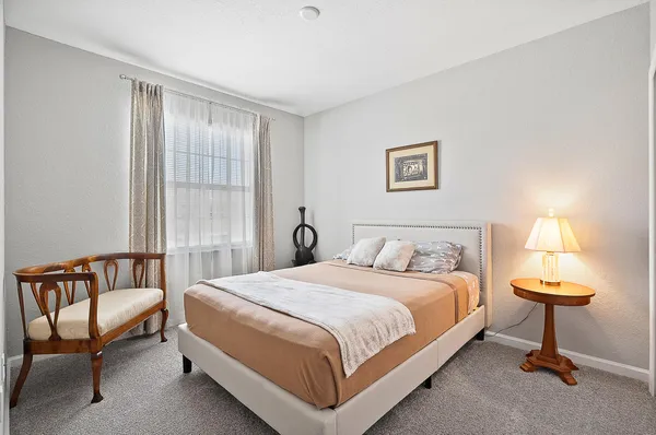 a bedroom with a bed and a couch