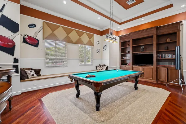 a room with pool tables and windows
