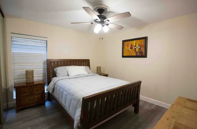 a bedroom with a bed and a tv