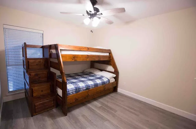 a bed sitting in a bedroom next to a window