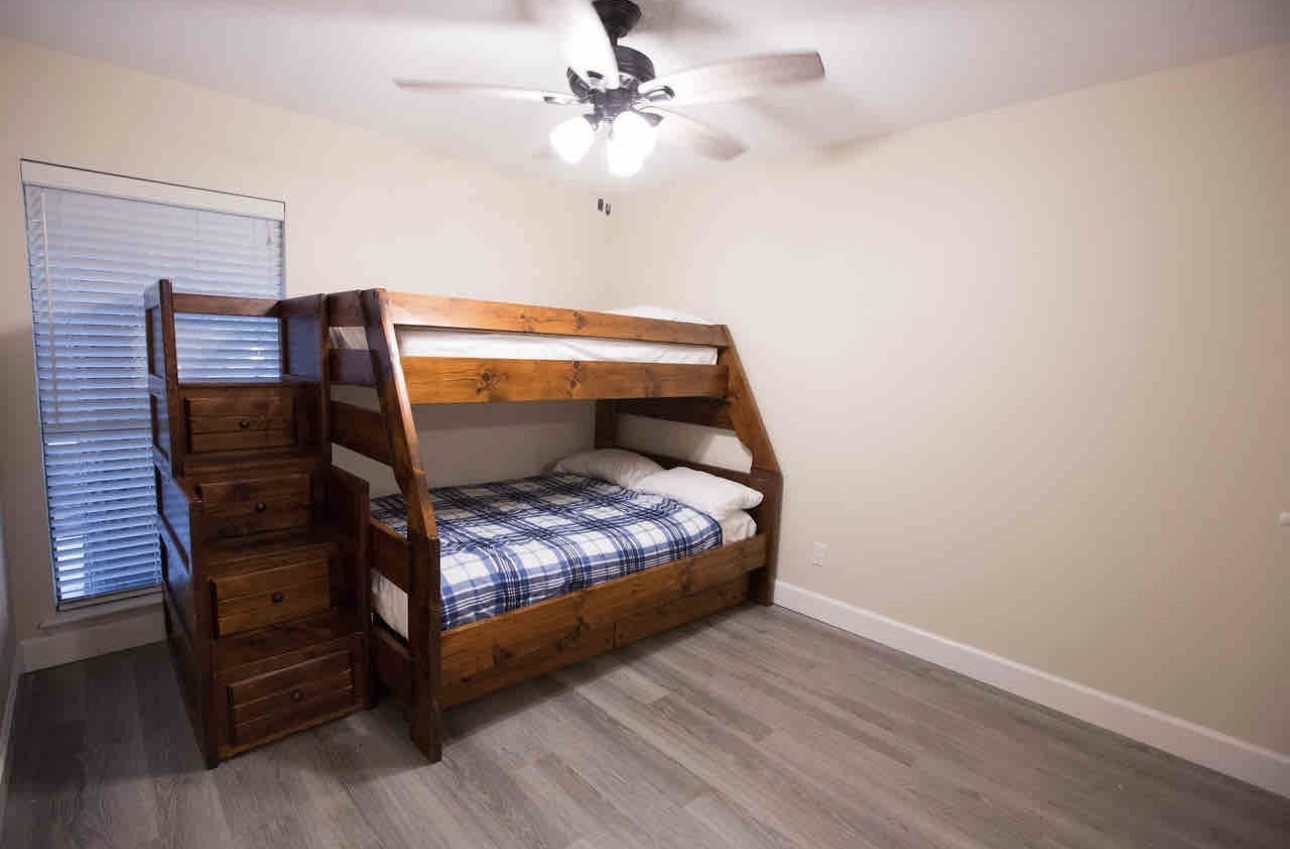 3007 Willowbend Road Montgomery, TX 77356 - Photo 31 of 43 a bed sitting in a bedroom next to a window