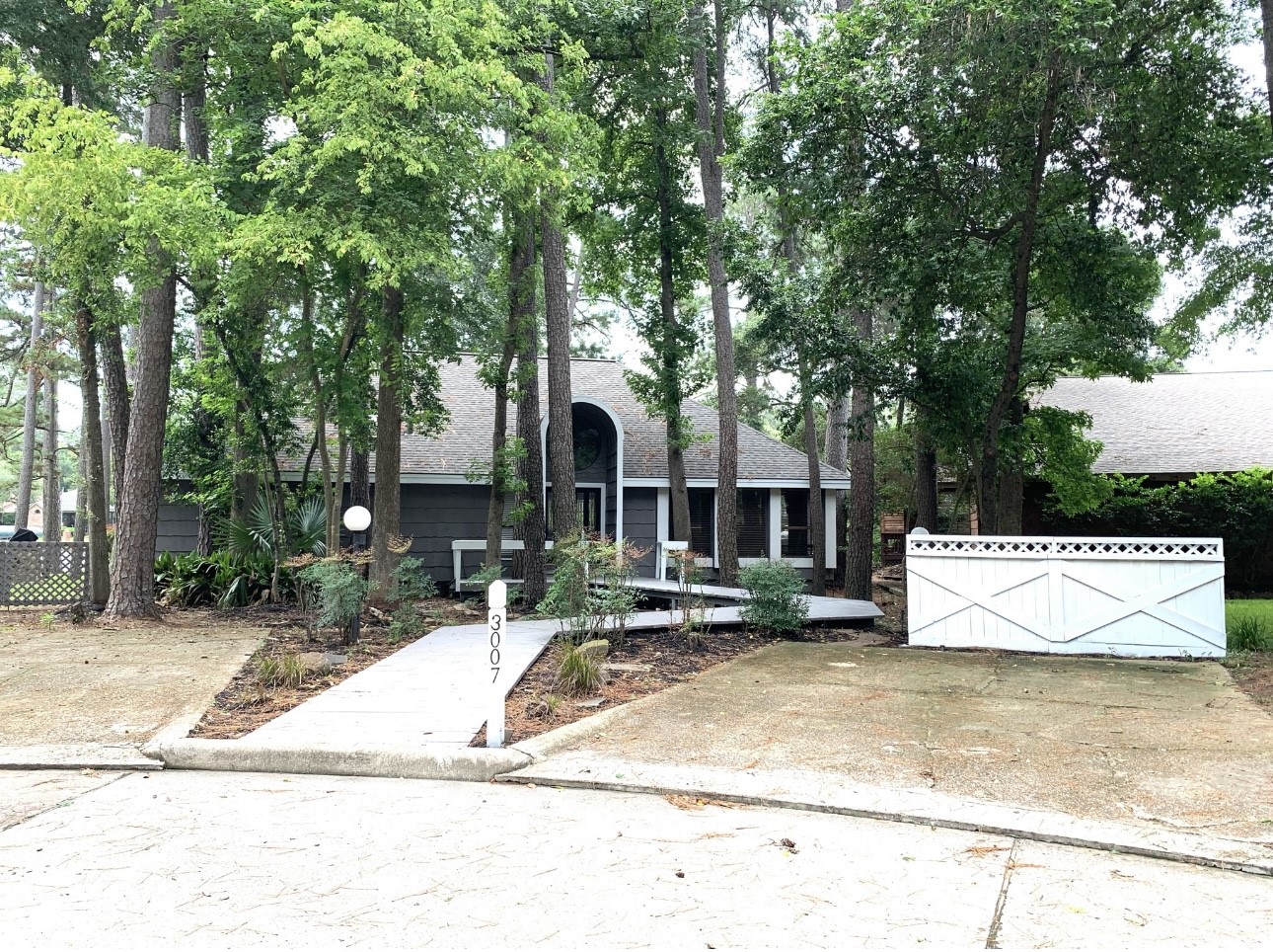 3007 Willowbend Road Montgomery, TX 77356 - Photo 8 of 43 a view of a white house with a outdoor space
