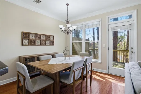 a view of a dining room with furniture wooden floor and chandelier