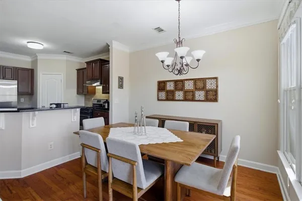 a view of a dining room with furniture window and wooden floor