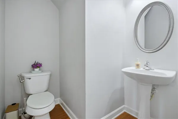 a white toilet sitting next to a bathroom sink
