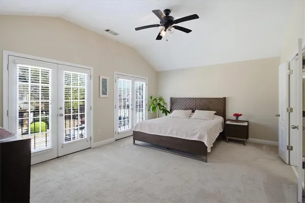 a spacious bedroom with a bed and a large window