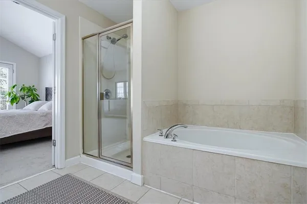 a spacious bathroom with a bathtub and shower