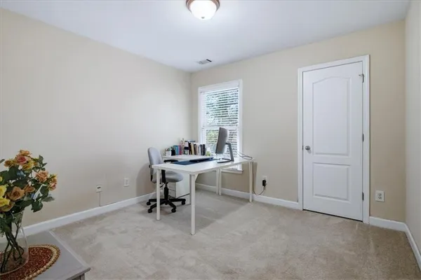 a view of a workspace with furniture and a potted plant
