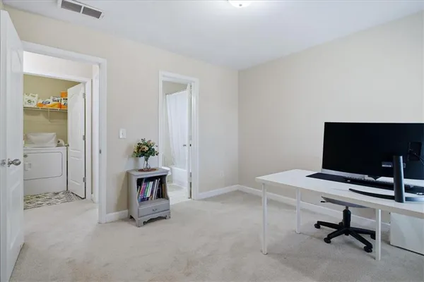 a view of a workspace with a window and a bathroom
