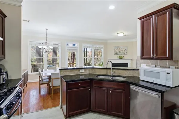 a kitchen with granite countertop a sink and cabinets