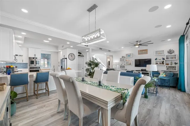 a kitchen with stainless steel appliances a refrigerator and a stove top oven