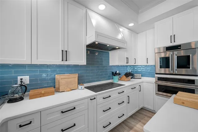 a bedroom with a balcony a bed and a table in it