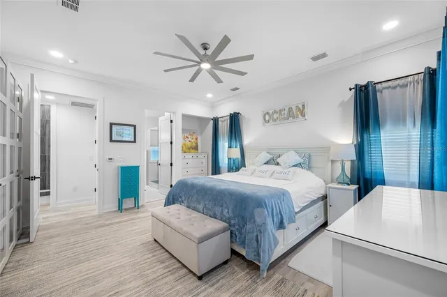 a living room with patio furniture and a potted plant