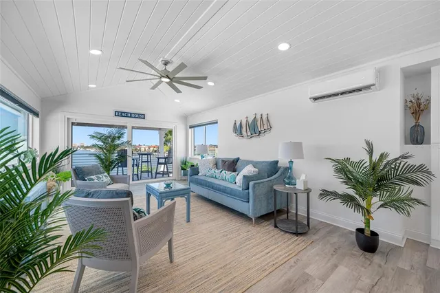 a living room with furniture potted plant and a ceiling fan