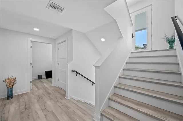 a view of hallway with wooden floor
