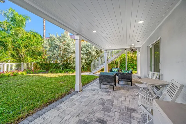 an aerial view of residential houses with outdoor space and swimming pool