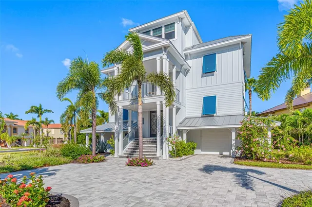 an aerial view of residential houses with outdoor space and lake view