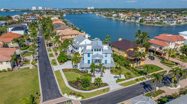 a view of a house with a big yard and potted plants