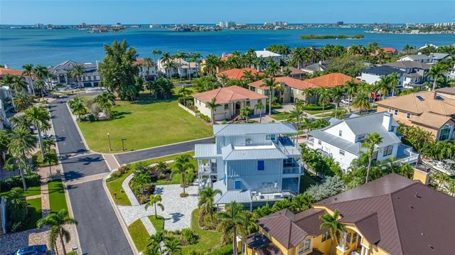 an aerial view of a house with outdoor space and lake view