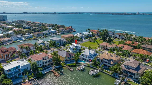 an aerial view of a house with swimming pool and outdoor seating