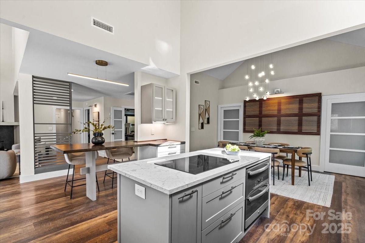 4308 Rounding Run Road Charlotte, NC 28277 - Photo 12 of 48 a kitchen with a table chairs stove and wooden floor