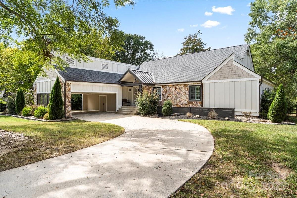 4308 Rounding Run Road Charlotte, NC 28277 - Photo 2 of 48 a front view of a house with a garden and porch