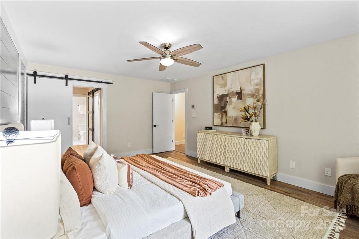 4308 Rounding Run Road Charlotte, NC 28277 - Photo 25 of 48 a bedroom with a bed and a chandelier