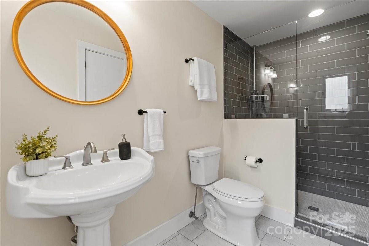 4308 Rounding Run Road Charlotte, NC 28277 - Photo 29 of 48 a bathroom with a sink a mirror a toilet and a shower