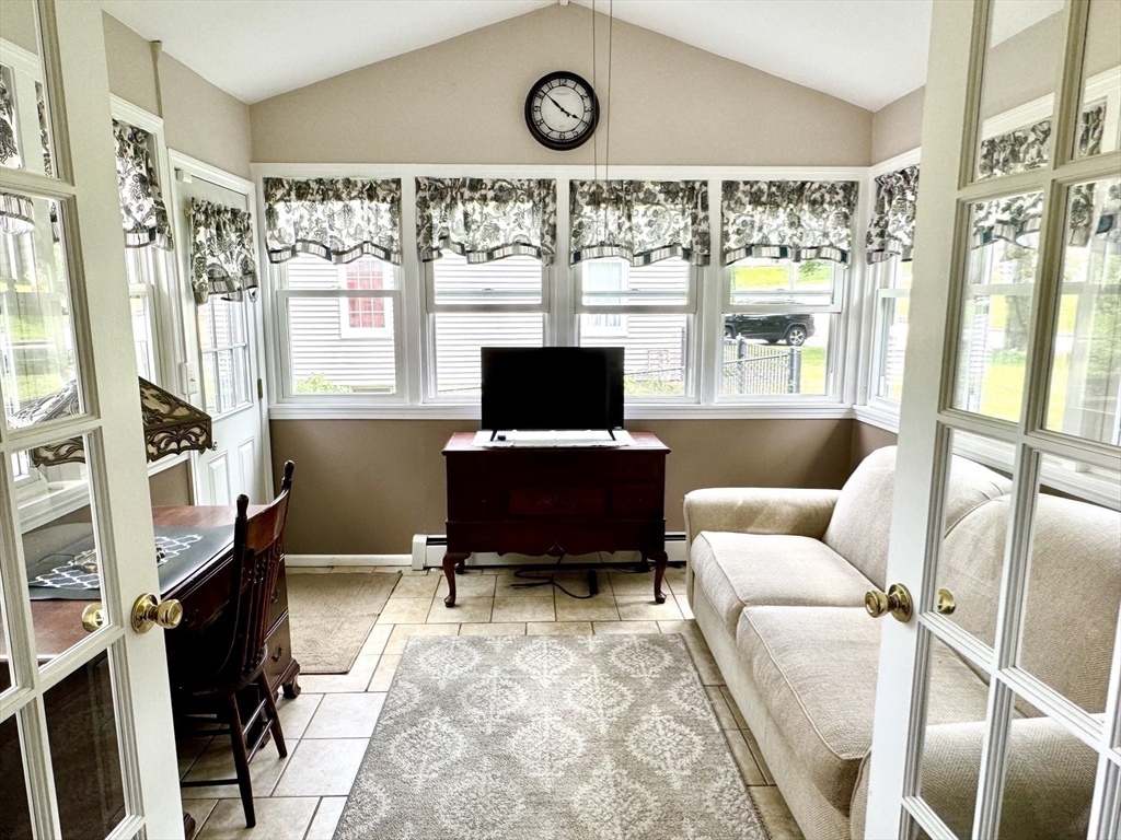 133 Bay State Road Worcester, MA 01606 - Photo 13 of 36 a living room with furniture a flat screen tv and a window