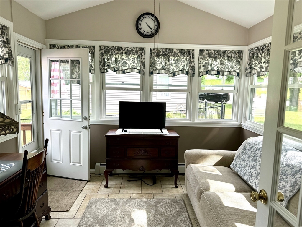 133 Bay State Road Worcester, MA 01606 - Photo 15 of 36 a living room with furniture a window and a flat screen tv