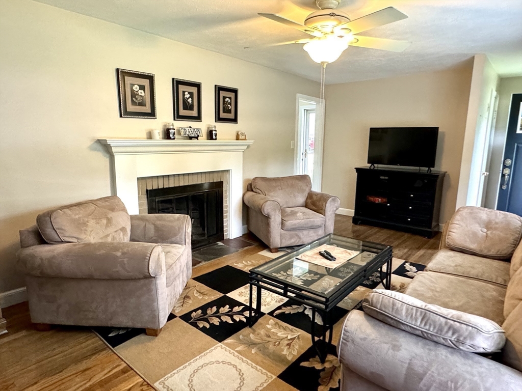 133 Bay State Road Worcester, MA 01606 - Photo 19 of 36 a living room with furniture a flat screen tv and a fireplace