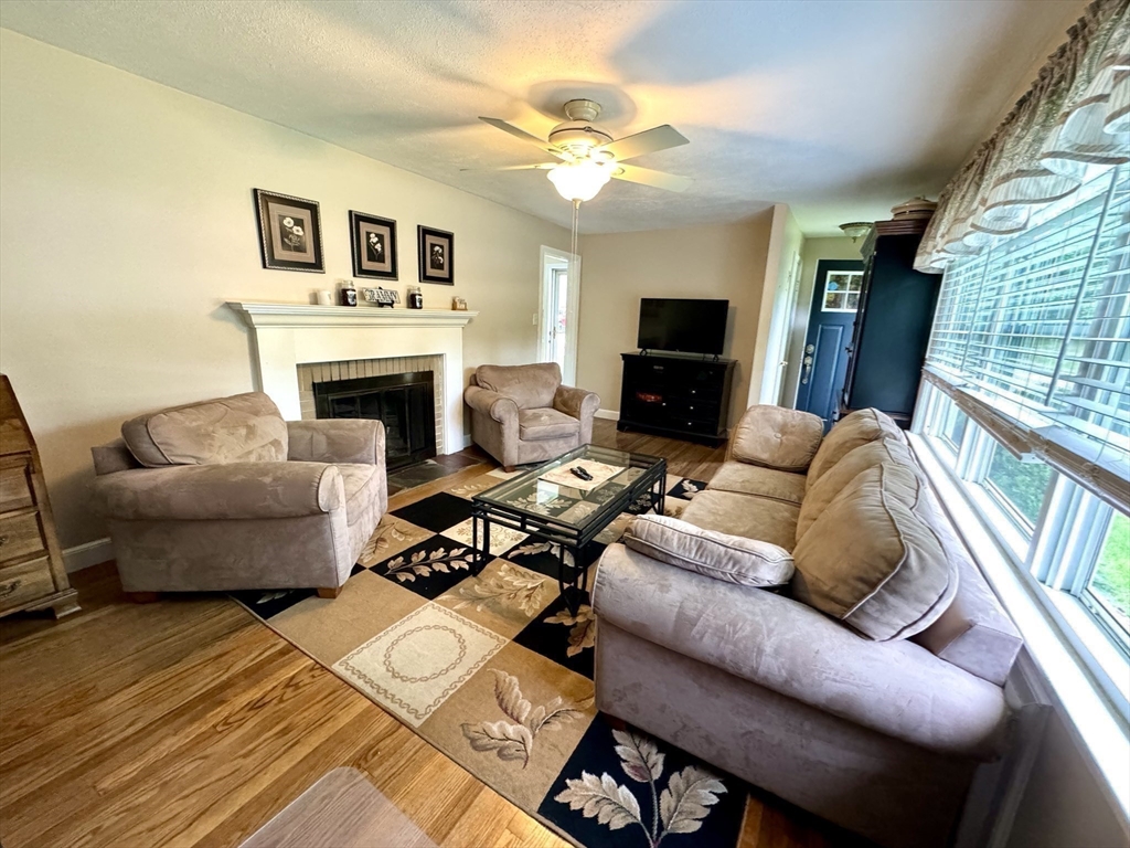 133 Bay State Road Worcester, MA 01606 - Photo 20 of 36 a living room with furniture a fireplace and a flat screen tv