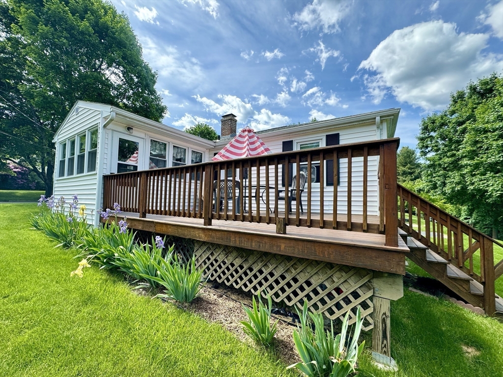 133 Bay State Road Worcester, MA 01606 - Photo 2 of 36 a view of a wooden house with a small yard and furniture