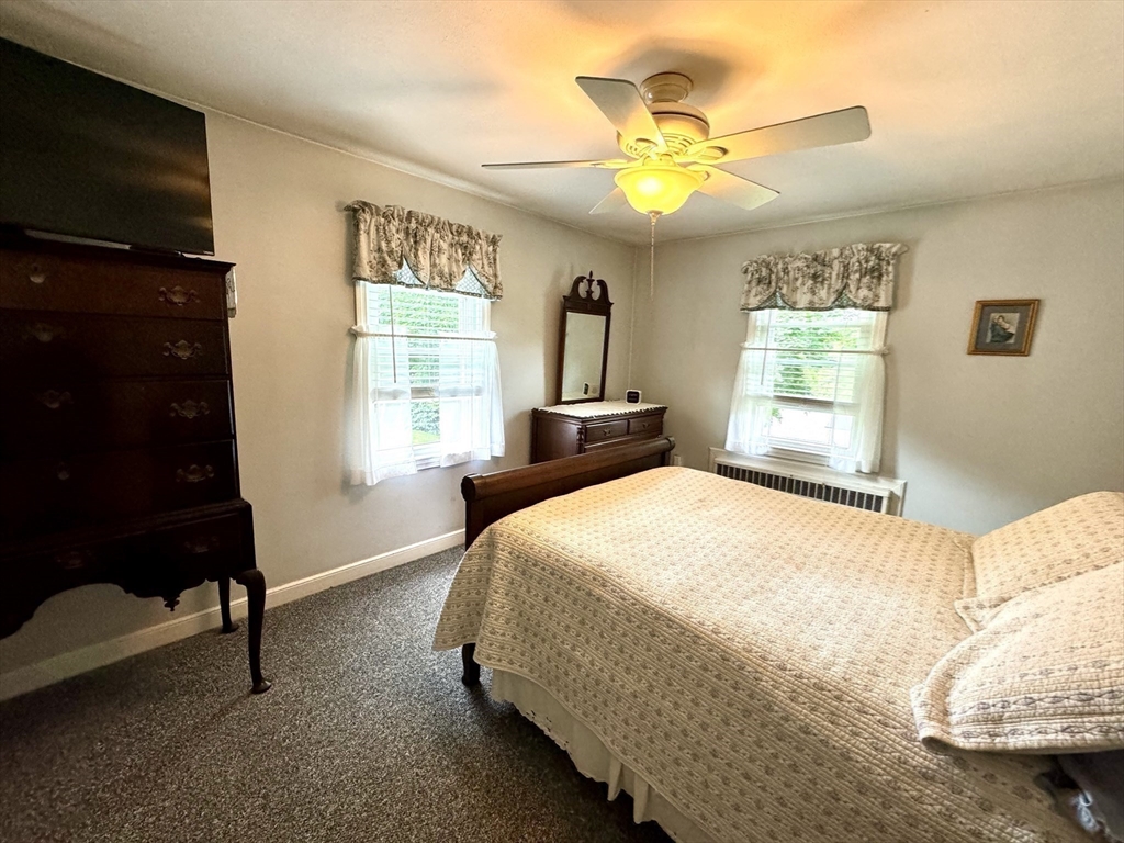 133 Bay State Road Worcester, MA 01606 - Photo 23 of 36 a bedroom with a bed and a chandelier