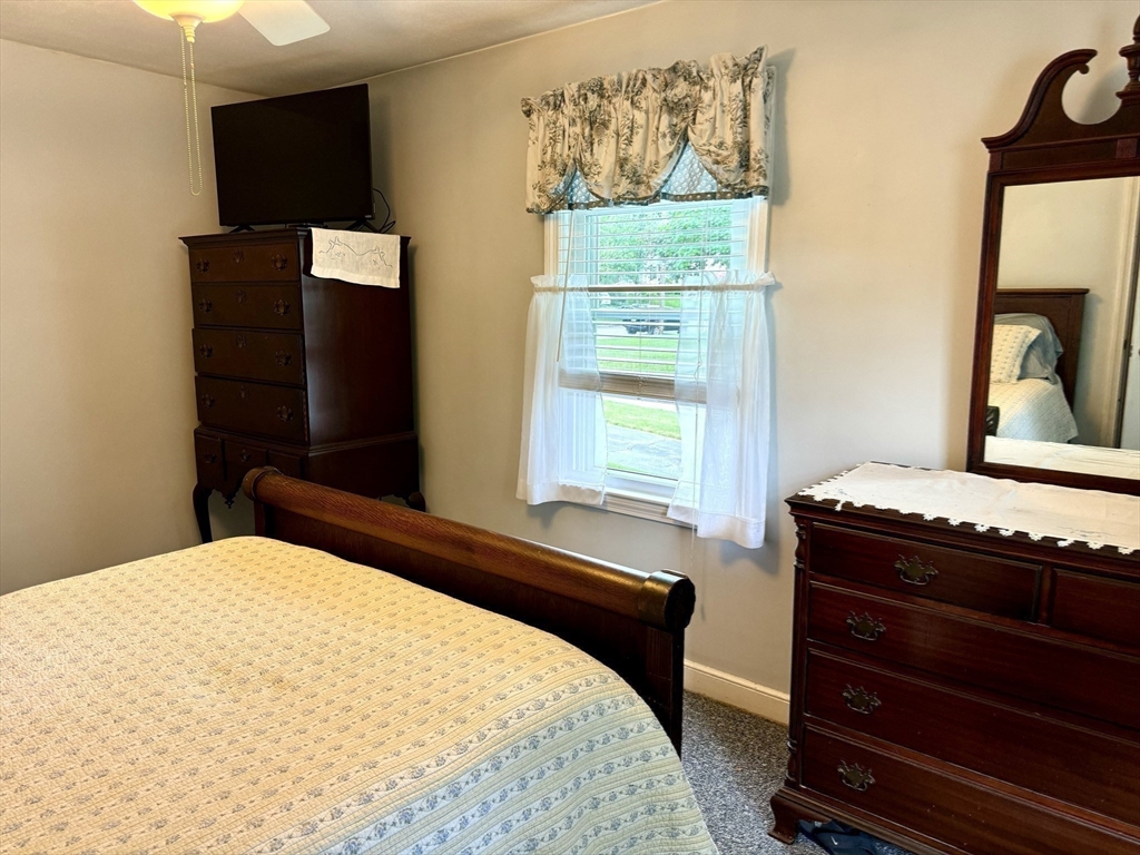 133 Bay State Road Worcester, MA 01606 - Photo 25 of 36 a bedroom with a bed and a dresser