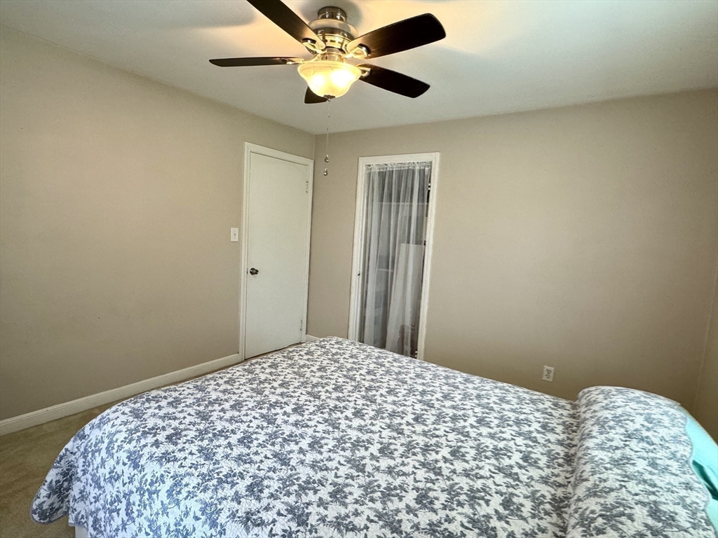 133 Bay State Road Worcester, MA 01606 - Photo 27 of 36 a bedroom with a bed and a chandelier