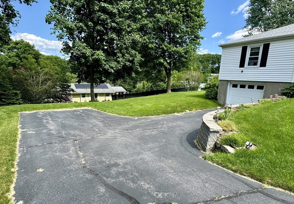 133 Bay State Road Worcester, MA 01606 - Photo 34 of 36 a front view of a house with a yard and trees