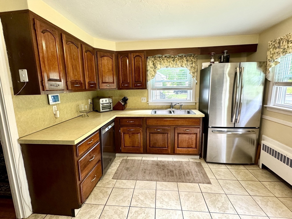 133 Bay State Road Worcester, MA 01606 - Photo 7 of 36 a kitchen with a stove a refrigerator and a sink