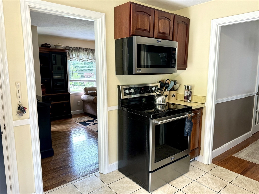 133 Bay State Road Worcester, MA 01606 - Photo 9 of 36 a kitchen with a stove and a microwave