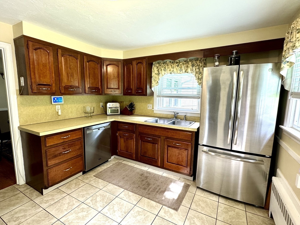 133 Bay State Road Worcester, MA 01606 - Photo 10 of 36 a kitchen with stainless steel appliances granite countertop a refrigerator sink and cabinets