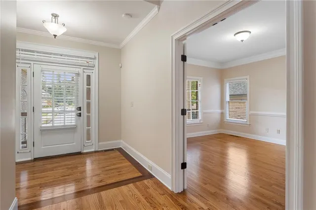 an empty room with a ceiling fan and window