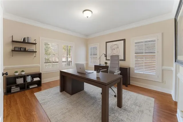 a spacious bathroom with a granite countertop sink a mirror and a bathtub