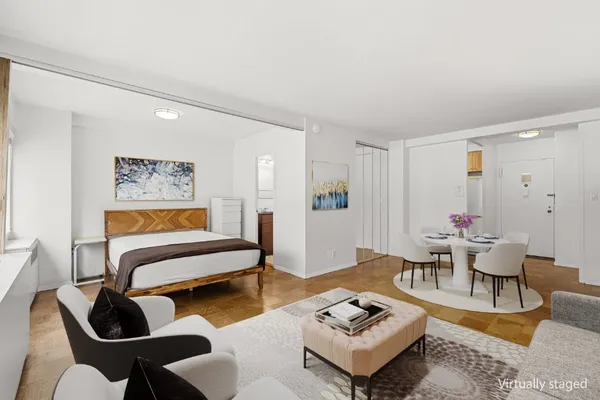 a living room with furniture and wooden floor